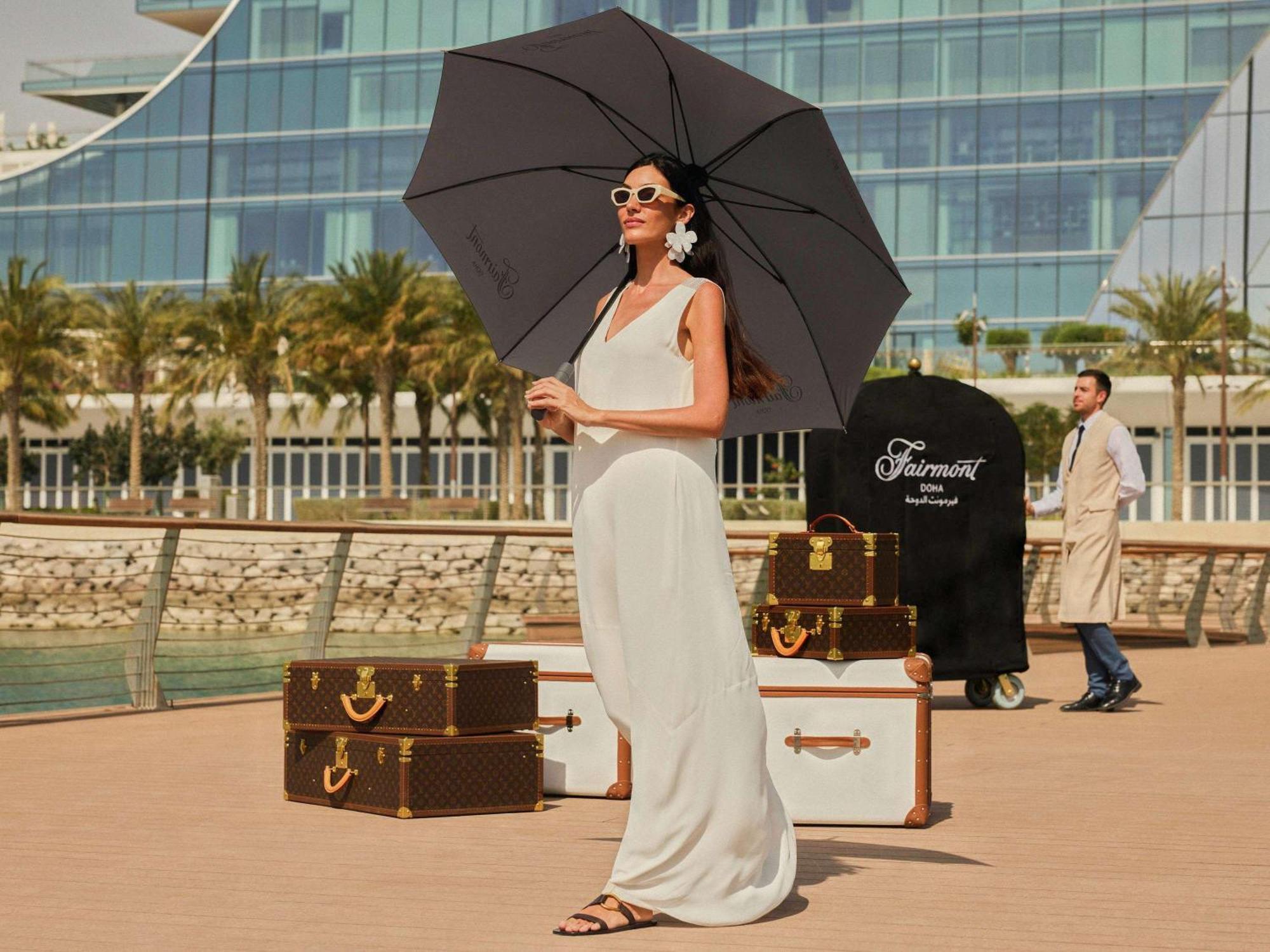 Fairmont Doha Hotel Lusail Ngoại thất bức ảnh A woman with a large umbrella